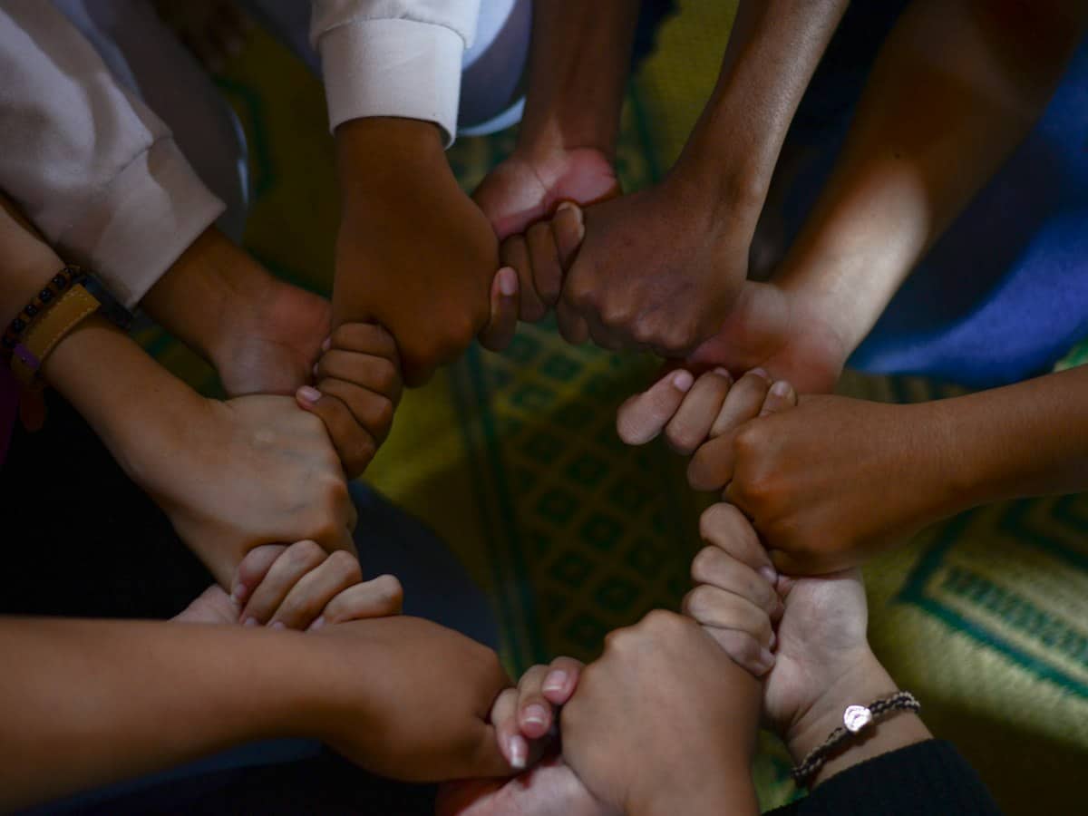 A circle of hands joined together